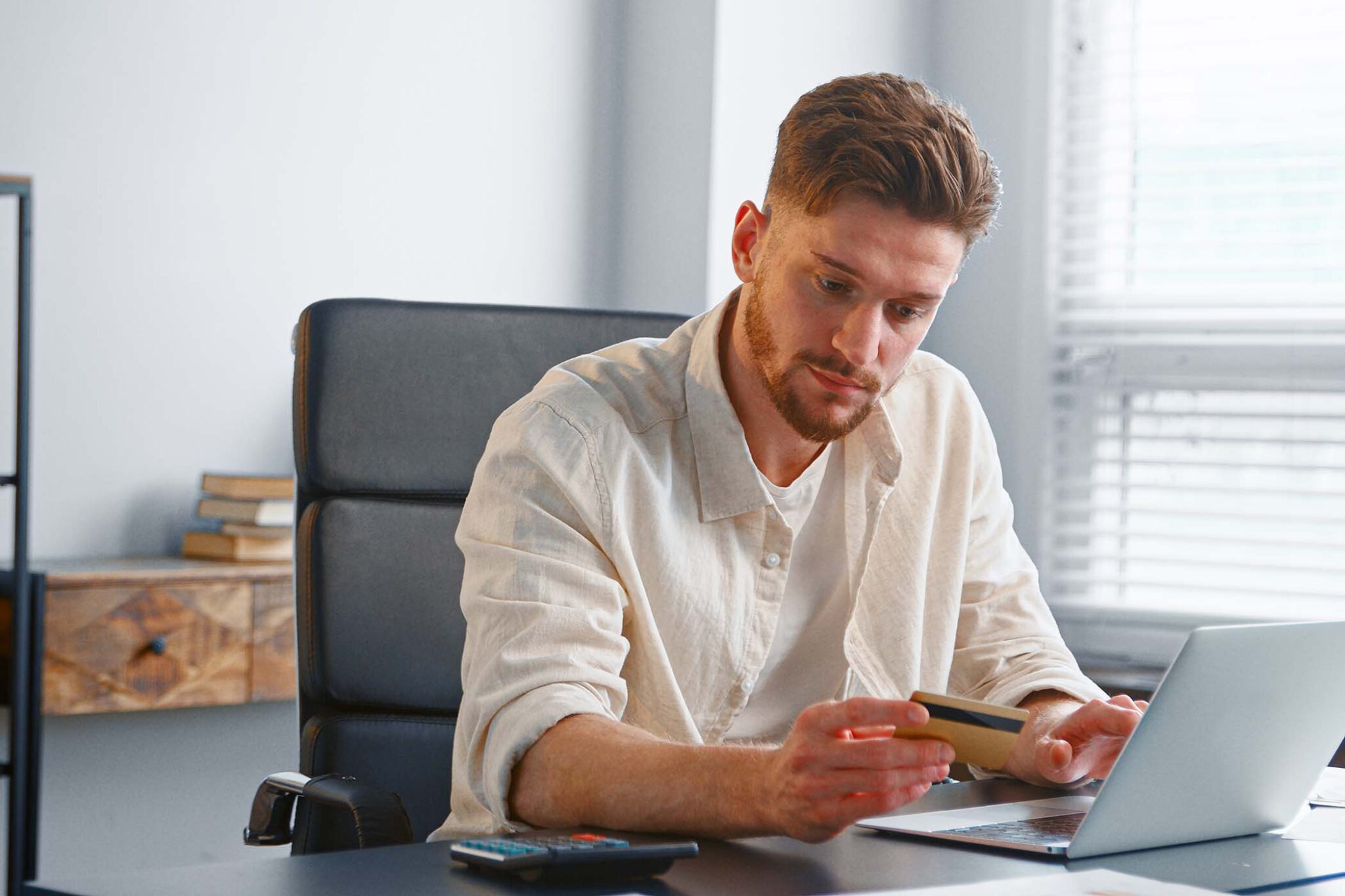 bearded-businessman-in-yellow-shirt-holds-bank-car-D3Y4KAA.jpg